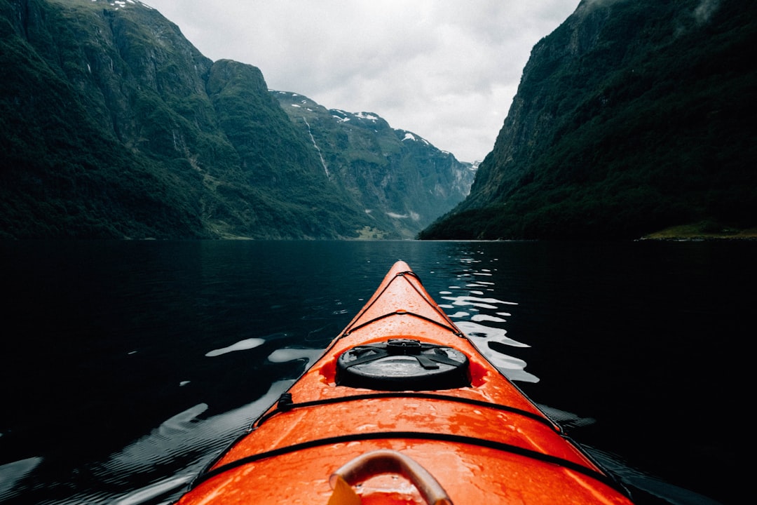 Traveler reviewing travel insurance coverage options for activities like hiking and skiing before a mountain trek.